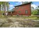 Rustic log cabin featuring multiple windows and a well-maintained exterior, great for peaceful living at 41513 Aspen St, Eustis, FL 32736