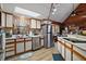 Well-lit kitchen featuring a stainless steel refrigerator, dishwasher, and a window with a view at 41513 Aspen St, Eustis, FL 32736