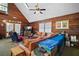 Cozy living room with wood paneled walls, leather seating and comfortable decor for relaxation at 41513 Aspen St, Eustis, FL 32736
