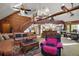 Cozy living room with a wood-burning fireplace, comfortable couches, and a staircase to the loft at 41513 Aspen St, Eustis, FL 32736