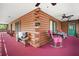 Large screened in porch with ceiling fans, log beams and carpet provides outdoor living space at 41513 Aspen St, Eustis, FL 32736
