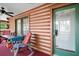 Screened porch featuring log walls, an exterior door and ceiling fans for outdoor relaxation and entertainment at 41513 Aspen St, Eustis, FL 32736