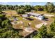 Spacious property featuring playground, picnic area, and ranch-style home surrounded by mature trees at 42191 Cashew St, Eustis, FL 32736