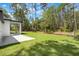 Expansive backyard with a large lawn and an appealing covered patio, perfect for outdoor living at 42191 Cashew St, Eustis, FL 32736