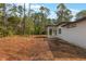 A modern single-story home features a minimalist backyard with a covered patio, ready for customization at 42191 Cashew St, Eustis, FL 32736
