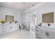 Clean, modern bathroom with dual vanities, marble floors, and stylish mirrors at 42191 Cashew St, Eustis, FL 32736