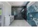 Modern bathroom features a glass-enclosed shower, sleek vanity, and luxurious marble accents at 42191 Cashew St, Eustis, FL 32736