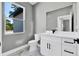 Bathroom featuring toilet, vanity with white cabinets and a bright window at 42191 Cashew St, Eustis, FL 32736