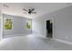 Spacious bedroom with two windows featuring a view at 42191 Cashew St, Eustis, FL 32736