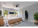 Bright bedroom with large windows, modern decor, and a ceiling fan at 42191 Cashew St, Eustis, FL 32736