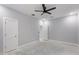 Spacious bedroom featuring a ceiling fan and two access doors at 42191 Cashew St, Eustis, FL 32736