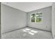 Bright bedroom with natural light streaming through a window, presenting a blank canvas for personalized design at 42191 Cashew St, Eustis, FL 32736