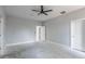 A spacious bedroom with gray walls and a ceiling fan creates a calming and minimalist aesthetic at 42191 Cashew St, Eustis, FL 32736
