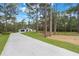 Lovely home with a long driveway, nestled among tall trees and lush greenery at 42191 Cashew St, Eustis, FL 32736