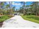 Beautifully landscaped home with a long driveway surrounded by mature trees at 42191 Cashew St, Eustis, FL 32736