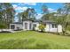 Inviting curb appeal with a well-maintained lawn, complemented by the home's contemporary exterior and landscaping at 42191 Cashew St, Eustis, FL 32736