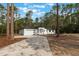 A modern single-story home boasts a clean white facade, a two-car garage and beautiful curb appeal at 42191 Cashew St, Eustis, FL 32736