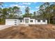 A modern single-story home boasts a clean white facade, a two-car garage and beautiful curb appeal at 42191 Cashew St, Eustis, FL 32736