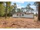 A modern single-story home features a minimalist backyard with a covered patio, ready for customization at 42191 Cashew St, Eustis, FL 32736