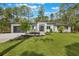 Beautiful single-story home with a modern design, well-manicured lawn, and a convenient two-car garage at 42191 Cashew St, Eustis, FL 32736