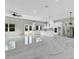 Expansive open kitchen and living area featuring sleek marble flooring, modern lighting, and high-end stainless steel appliances at 42191 Cashew St, Eustis, FL 32736