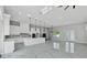 Spacious kitchen with an open layout, featuring marble floors, modern lighting fixtures, and a large center island at 42191 Cashew St, Eustis, FL 32736