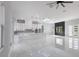 Large kitchen features white cabinets, modern appliances, a center island and modern lighting at 42191 Cashew St, Eustis, FL 32736