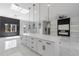 Bright, open kitchen features a large island, modern lighting, and black accent wall at 42191 Cashew St, Eustis, FL 32736