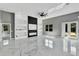 Spacious living area with marble floors, a decorative accent wall, built-in shelving, and neutral color scheme, perfect for modern living at 42191 Cashew St, Eustis, FL 32736