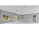 Bright, spacious living room showing windows, doors and concrete floors at 42191 Cashew St, Eustis, FL 32736