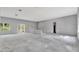 Unfinished living room showing concrete floors and bright windows for natural light at 42191 Cashew St, Eustis, FL 32736