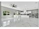 Open-concept living space with a kitchen, gray walls, modern lighting, and marble floors, offering a stylish and spacious design at 42191 Cashew St, Eustis, FL 32736
