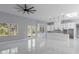 Open-concept living space with modern finishes, white cabinetry, and abundant natural light at 42191 Cashew St, Eustis, FL 32736