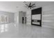 Expansive living area with modern ceiling fan, fireplace, and bright natural light at 42191 Cashew St, Eustis, FL 32736