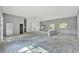 Spacious living room showing built-in shelves, windows, and concrete floors at 42191 Cashew St, Eustis, FL 32736