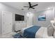Modern bedroom with large bed, accent rug, dresser, and TV at 42191 Cashew St, Eustis, FL 32736