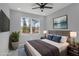 Cozy bedroom with a large window offering peaceful nature views, with gray color palette at 42191 Cashew St, Eustis, FL 32736