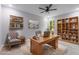 A home office space with built in shelves, gray walls, modern desk and chair at 42191 Cashew St, Eustis, FL 32736