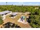 Aerial view of a community playground and picnic area nestled among lush trees, promoting outdoor Gathering fun at 42191 Cashew St, Eustis, FL 32736