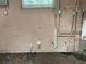 The basement wall shows extensive water damage and exposed plumbing at 447 E Desoto St, Clermont, FL 34711