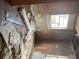 Bedroom in need of repair with peeling paint, debris and flooring waiting to be installed at 447 E Desoto St, Clermont, FL 34711