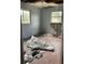 Bedroom with two windows, peeling paint, and visible damage, needs renovation at 447 E Desoto St, Clermont, FL 34711