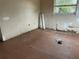 This bedroom features peeling paint, damaged walls, and old tile flooring at 447 E Desoto St, Clermont, FL 34711