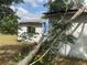 Exterior of property with structural damage and tree debris at 447 E Desoto St, Clermont, FL 34711