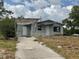 Modest single-Gathering home with a cinder block exterior and an unfinished pergola at 447 E Desoto St, Clermont, FL 34711