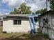 Exterior of home with roof damage and yard debris at 447 E Desoto St, Clermont, FL 34711