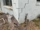 Corner foundation of home in need of repair with yard debris at 447 E Desoto St, Clermont, FL 34711