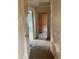Hallway with peeling paint, damaged walls, and doorways leading to other rooms at 447 E Desoto St, Clermont, FL 34711