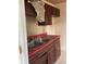 This outdated kitchen features worn cabinets, double sink, and significant damage at 447 E Desoto St, Clermont, FL 34711