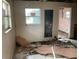 This living room features damaged flooring, peeling paint, and natural light at 447 E Desoto St, Clermont, FL 34711